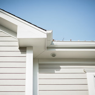 Inspiration for a large timeless gray two-story concrete fiberboard exterior home remodel in Chicago with a mixed material roof