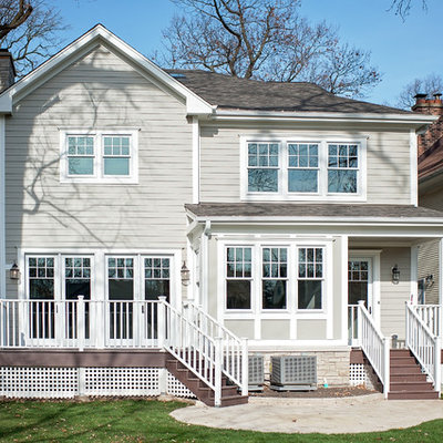 Large elegant gray two-story concrete fiberboard exterior home photo in Chicago with a mixed material roof