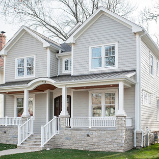 Large elegant gray two-story concrete fiberboard exterior home photo in Chicago with a mixed material roof