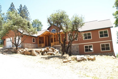 Large traditional brown two-story exterior home idea in Other with a shingle roof