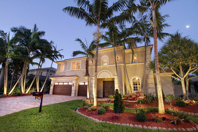 Huge tuscan beige two-story concrete exterior home photo in Miami