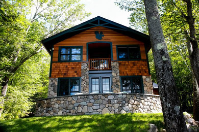 Diseño de fachada de casa marrón de estilo americano grande de dos plantas con revestimiento de madera, tejado a dos aguas y tejado de teja de madera