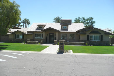 Large traditional beige two-story stucco exterior home idea in Phoenix with a shingle roof