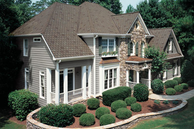 Large traditional gray two-story vinyl exterior home idea in New York