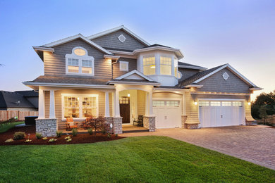 Example of a mid-sized arts and crafts gray two-story wood exterior home design in Other with a shingle roof