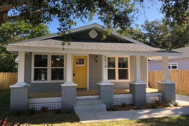 Mid-sized 1950s gray one-story mixed siding house exterior photo in Tampa with a shed roof and a shingle roof
