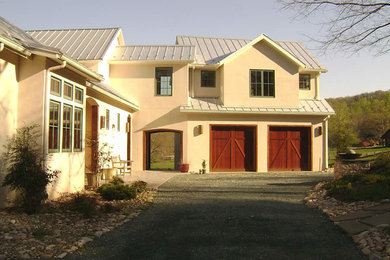 Mid-sized transitional beige two-story stucco exterior home photo in Indianapolis with a metal roof