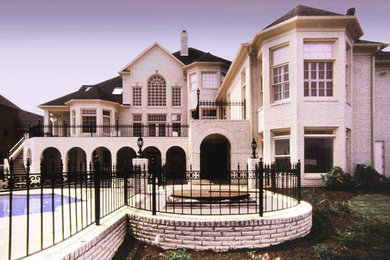 Huge elegant white three-story brick house exterior photo in Other with a shingle roof and a gray roof