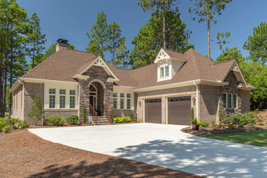 Example of a large transitional brown two-story mixed siding house exterior design in Raleigh with a shingle roof