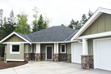 Arts and crafts green two-story wood gable roof photo in Vancouver