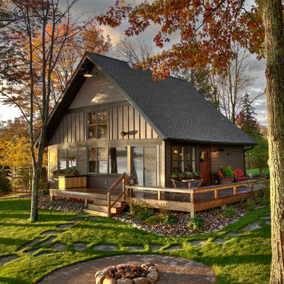 Rustic brown wood exterior home idea in Minneapolis with a shingle roof