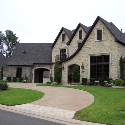 Large elegant beige two-story mixed siding exterior home photo in New Orleans with a hip roof