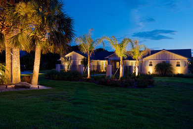 Large beach style beige one-story brick house exterior photo in Jacksonville with a hip roof and a shingle roof
