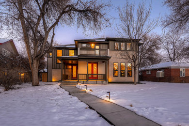 Inspiration for a large modern beige three-story stone exterior home remodel in Denver with a shed roof