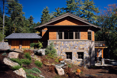 Photo of a contemporary house exterior in Boston with three floors and wood cladding.