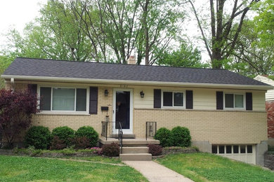 This is an example of a medium sized and beige classic bungalow house exterior in Cincinnati with mixed cladding.