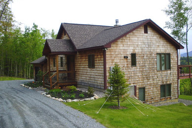 Mountain style brown two-story wood exterior home photo in Burlington