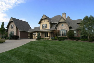 Example of a huge beige two-story mixed siding exterior home design in Cincinnati