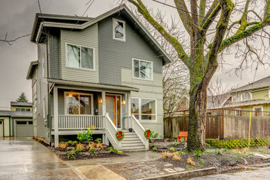 Mid-sized modern green two-story wood gable roof idea in Portland