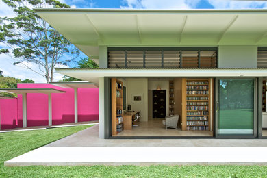 Photo of a large contemporary bungalow house exterior in Sydney with a lean-to roof and a pink house.