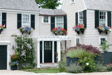 Inspiration for a large timeless white two-story wood exterior home remodel in Boston with a hip roof