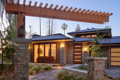 Large trendy brown two-story wood house exterior photo in San Francisco with a hip roof and a metal roof