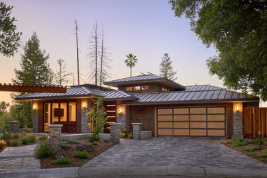 Large mountain style brown two-story mixed siding house exterior photo in San Francisco with a hip roof and a metal roof
