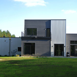 Example of a mid-sized minimalist gray two-story metal flat roof design in Minneapolis