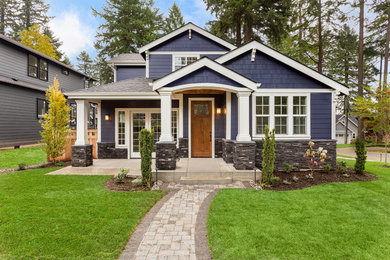 Inspiration for a timeless blue two-story wood exterior home remodel in Other with a shingle roof