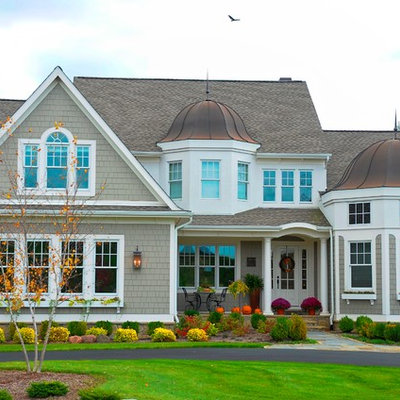Large elegant beige two-story wood exterior home photo in Detroit with a mixed material roof