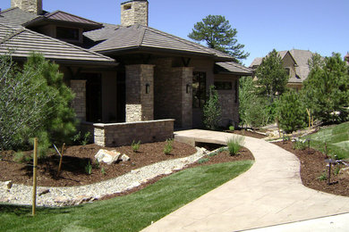 Example of a large beige one-story stone exterior home design in Denver