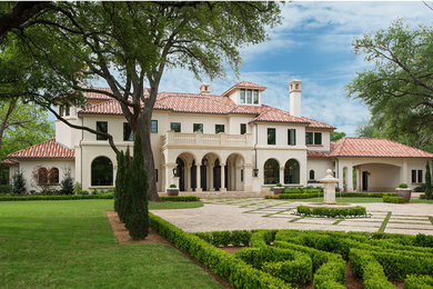 Inspiration for a huge mediterranean beige two-story stucco exterior home remodel in Dallas with a tile roof