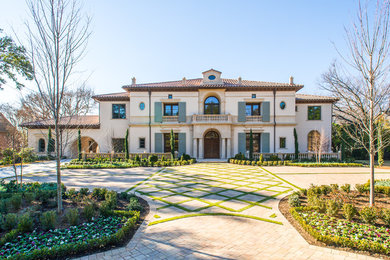 Example of a large tuscan two-story stucco exterior home design in Dallas
