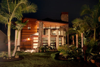 Large trendy brown two-story mixed siding flat roof photo in Orange County