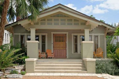 Small island style beige one-story wood exterior home photo in Other with a tile roof