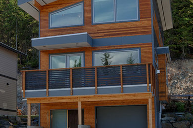 Example of a mid-sized minimalist brown three-story mixed siding exterior home design in Vancouver with a shed roof