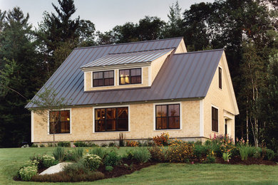 Example of a mid-sized arts and crafts two-story wood exterior home design in Portland Maine
