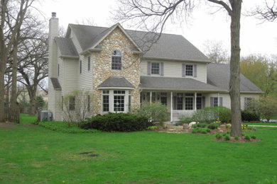 Large elegant beige two-story mixed siding exterior home photo in Chicago with a shingle roof