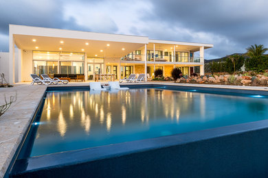 Inspiration for a large modern white two-story stucco house exterior remodel in Miami