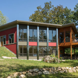 Foto de fachada de casa roja, contemporánea, pequeña, de dos plantas, con revestimiento de aglomerado de cemento y tejado plano