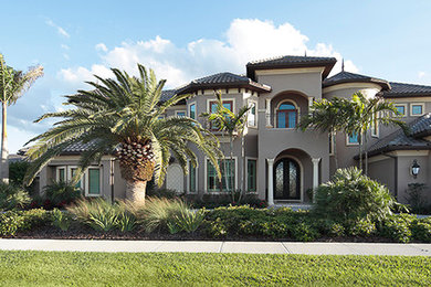 Traditional beige two-story stucco house exterior idea in Orlando