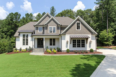 Inspiration for a transitional white two-story wood exterior home remodel in Raleigh with a shingle roof