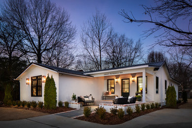 Small transitional white one-story wood house exterior photo in Birmingham with a clipped gable roof and a metal roof