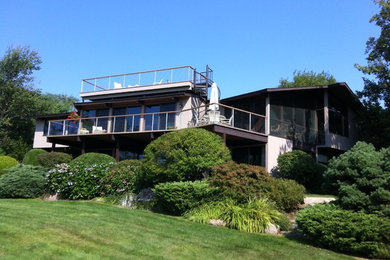 Inspiration for a modern gray wood gable roof remodel in Boston