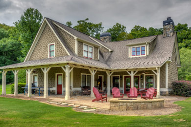 Example of a mid-sized classic brown one-story stone exterior home design in Atlanta with a shingle roof
