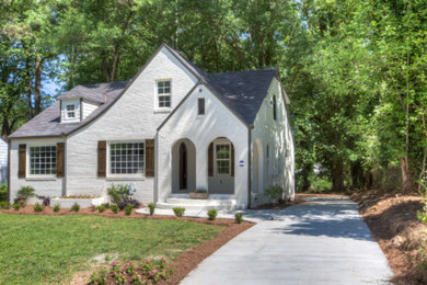 Mid-sized traditional white one-story brick exterior home idea in Atlanta with a shingle roof