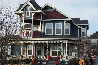 Large victorian blue two-story wood exterior home idea in Denver with a shingle roof