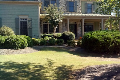 This is an example of a green traditional house exterior in Atlanta.