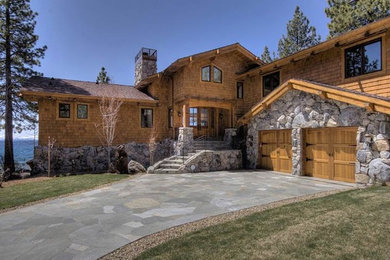 Example of a large mountain style brown two-story wood exterior home design in Sacramento with a clipped gable roof