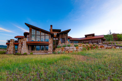 Inspiration for a large rustic gray two-story mixed siding house exterior remodel in Salt Lake City with a shed roof and a metal roof